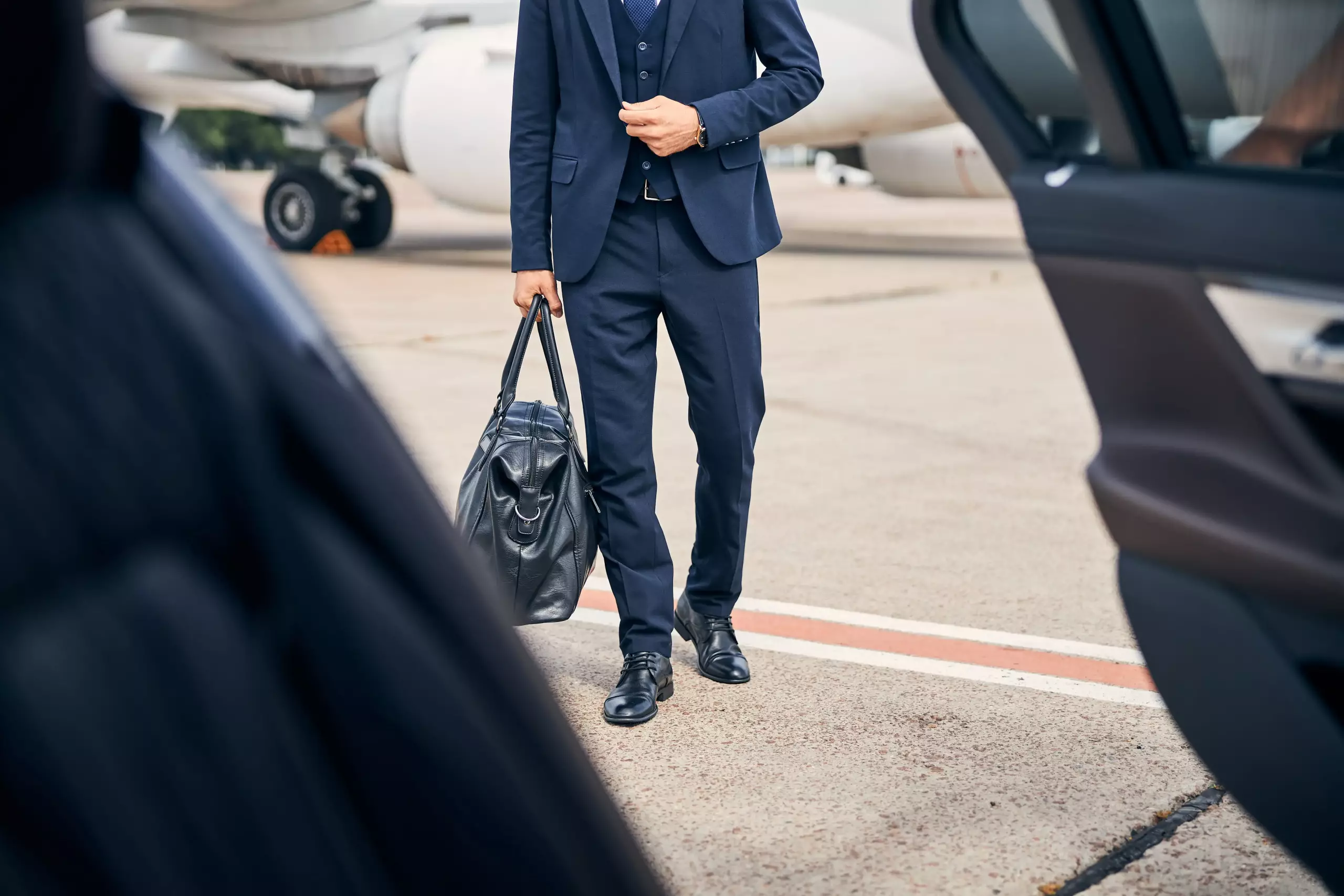 stylish businessman looking stylish walking towards car going business trip min scaled
